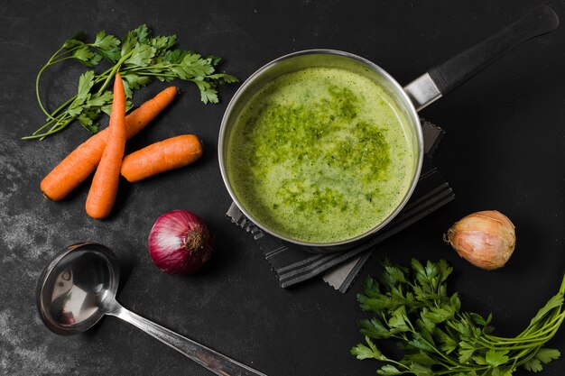 Top view of soup pot with carrots and onion