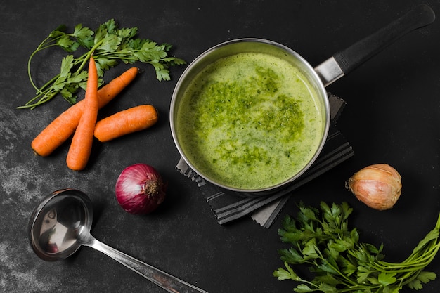 Top view of soup pot with carrots and onion