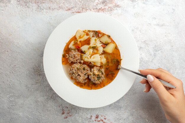 Top view soup with meat delicious soup with pasta and meat on light background