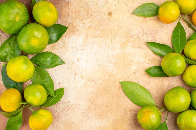 Top view sour green tangerines on a light background