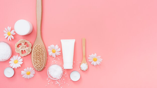 Top view of spa essentials surrounded by chamomile flowers