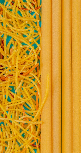 Top view of spaghetti and bucatini on blue surface – Free Stock Photo