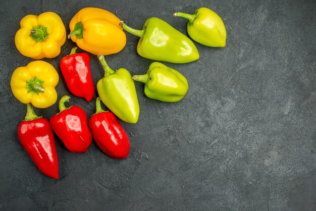 Top view spicy bell-peppers on the dark background