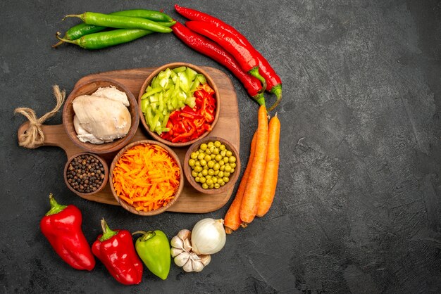 Top view spicy peppers with beans chicken and carrot on dark table color salad ripe fresh