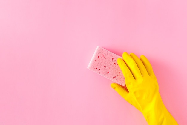 Top view of sponge and glove on plain background