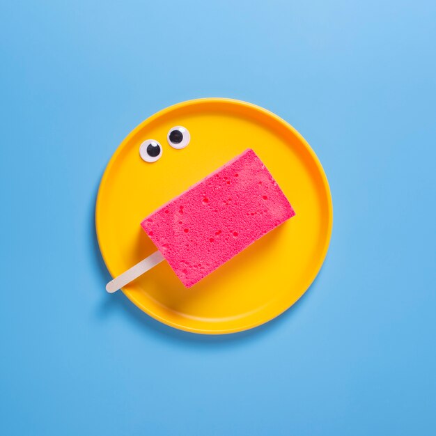 Top view of sponge on plate with blue background