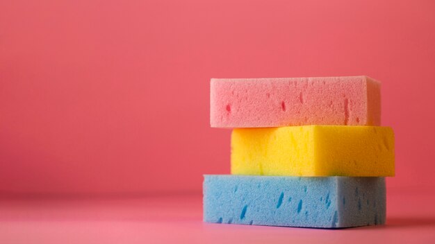 Top view of sponges on plain background with copy space