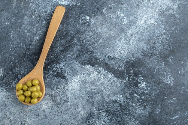 Top view of spoon canned peas