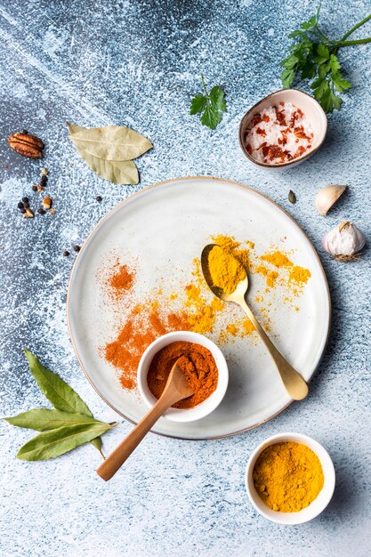 Top view spoons with spices on plate