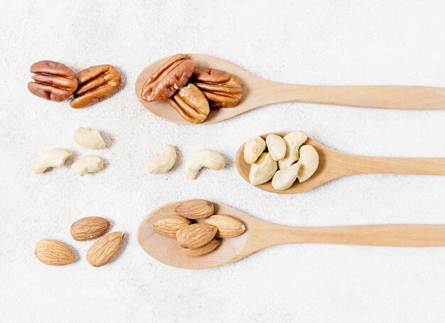 Top view of spoons with walnuts and almonds