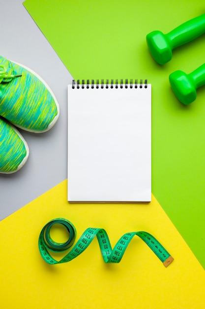 Top view sports equipment and notebook mock-up