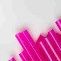 Free photo top view spread purple plastic straws