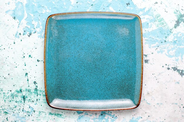 Top view square plate blue colored empty on light-blue surface plate glass color food