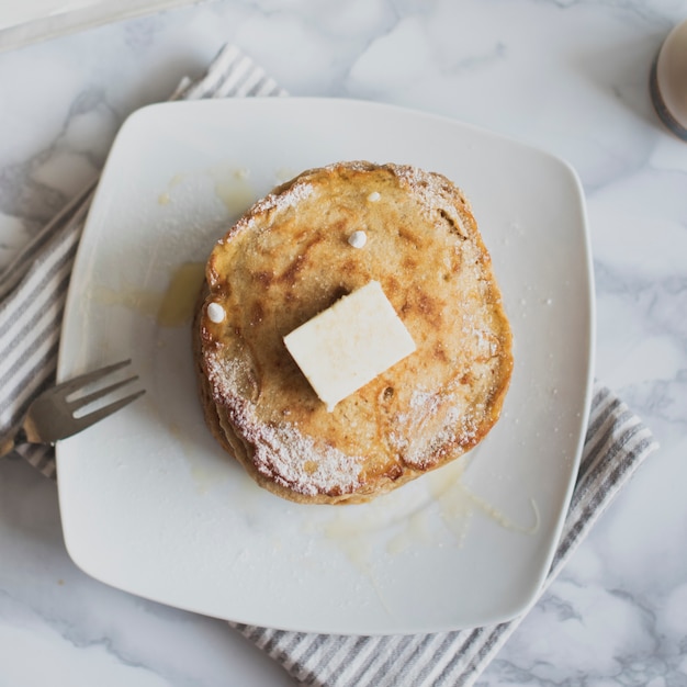 Top view stack of pancakes with butter