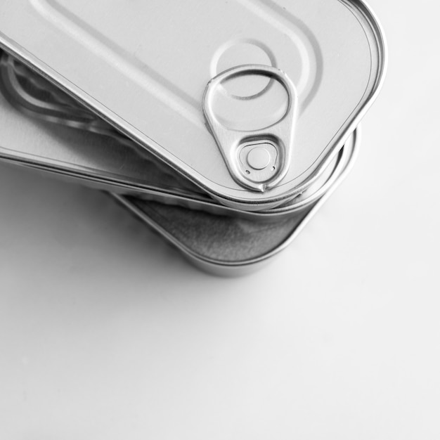 Free photo top view stack of silver tin cans with copy-space