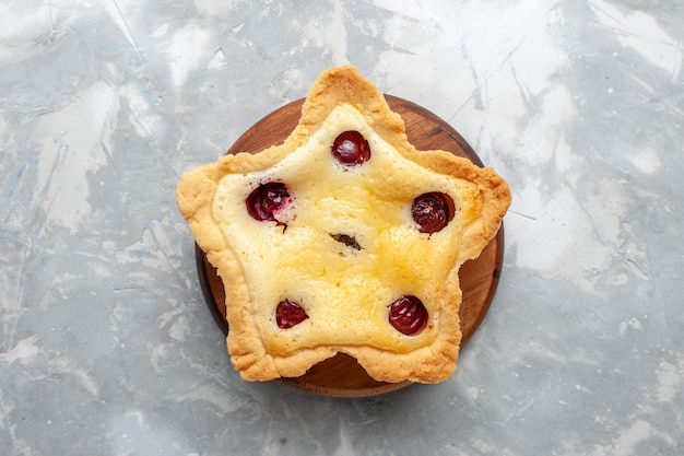 Top view star shaped cake with cherries inside on the light desk cake biscuit sweet sugar color photo