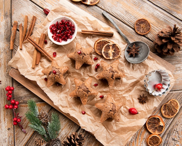 Top view of star-shaped cookies with pomegranate and cinnamon