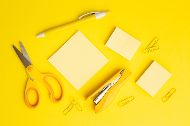 Top view stationary arrangement on yellow background