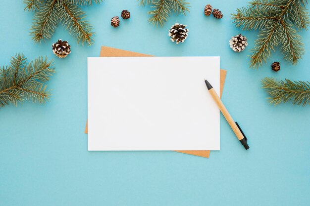 Top view stationery empty papers with conifer cones