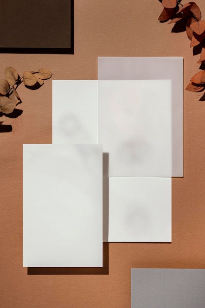 Free photo top view of stationery papers with leaves