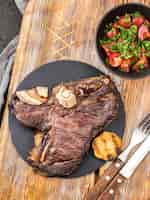 Free photo top view of steak with salad