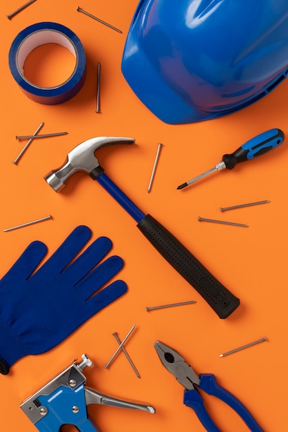 top view of steel hammer with other construction elements and tools