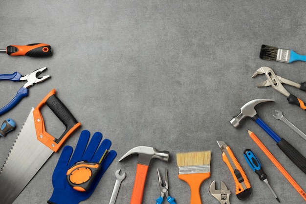 Top view of steel hammer with other construction elements and tools