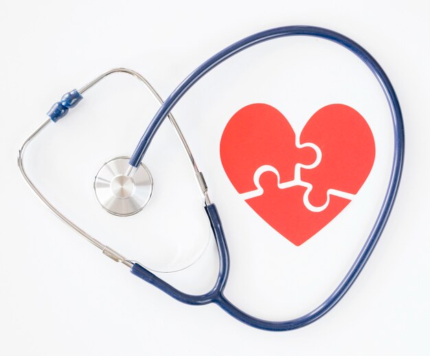 Top view of stethoscope with puzzle paper heart