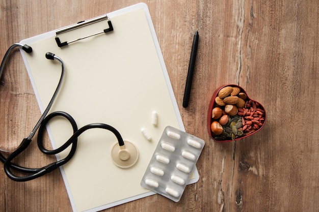 Top view stethoscope with tablets on the table