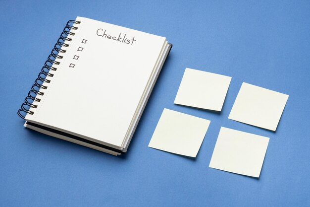 Top view sticky notes with to do list and notebook beside