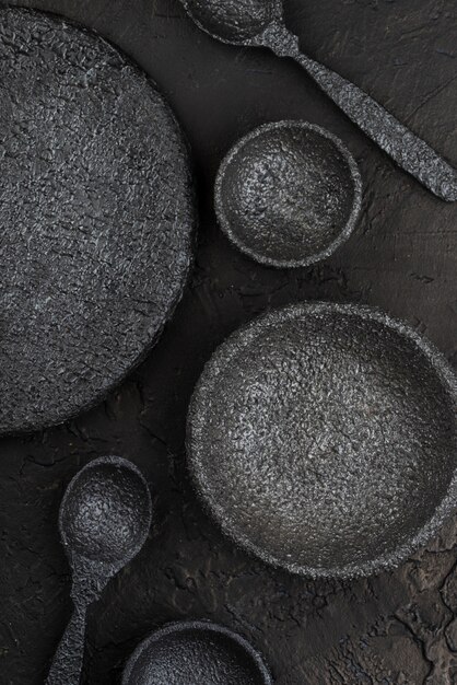 Top view of stone bowls and spoons on slate