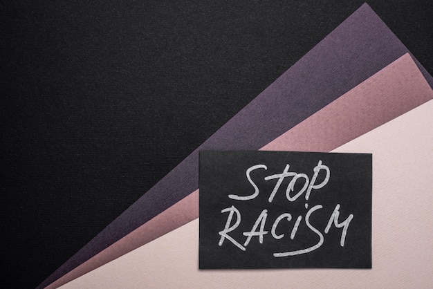 Top view of stop racism card on multicolored paper with copy space