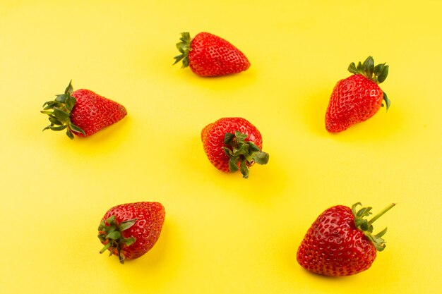 top view strawberries isolated on the yellow background