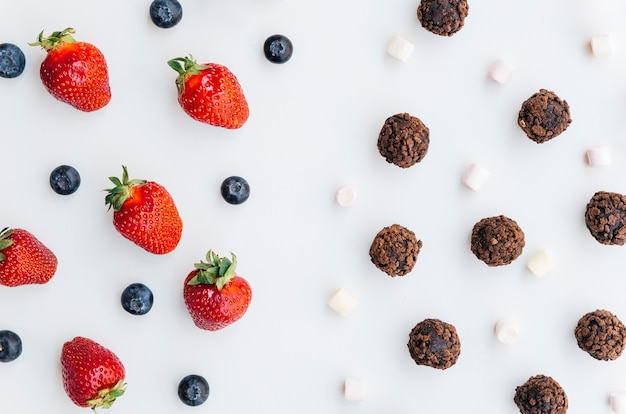 Top view strawberries vs chocolates