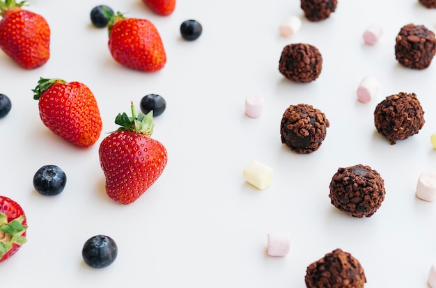 Top view strawberries vs chocolates