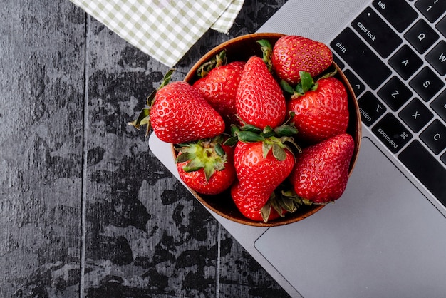 Top view strawberry in a bowl on black blackground