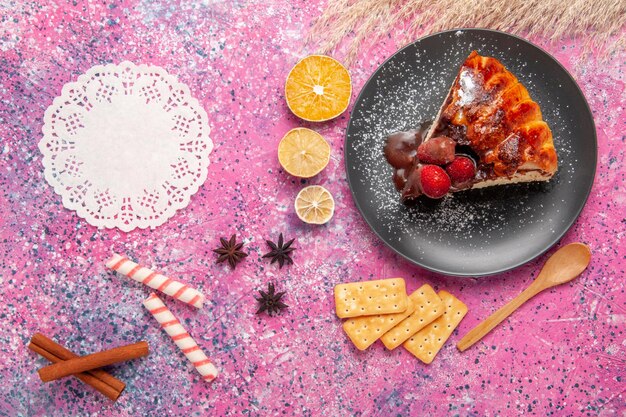 Top view strawberry chocolate cake with   and crisps on pink surface