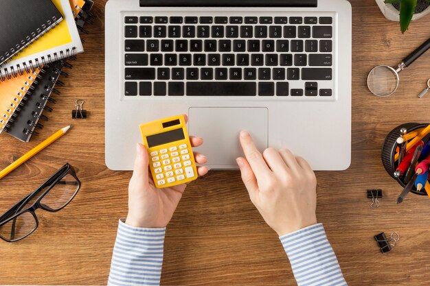 Free photo top view student holding calculator