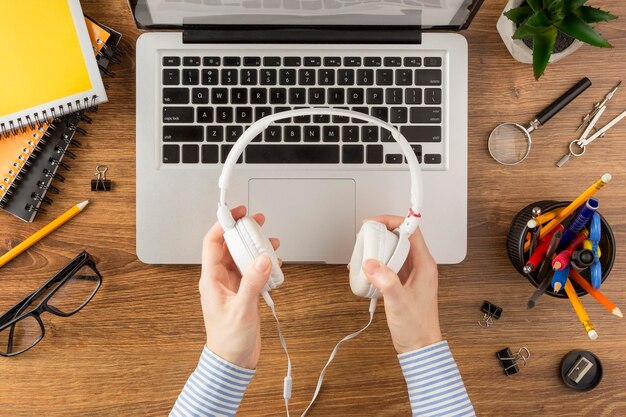 Top view student holding headphones