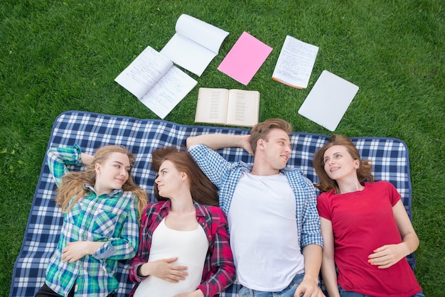 Top view of students lying on picnic blanket