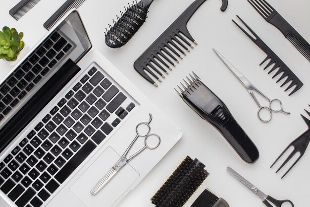 Top view stylist tools and laptop