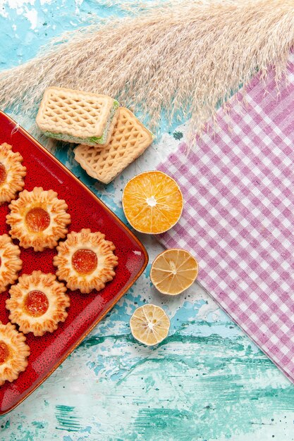 Top view sugar cookies with waffles on the blue background