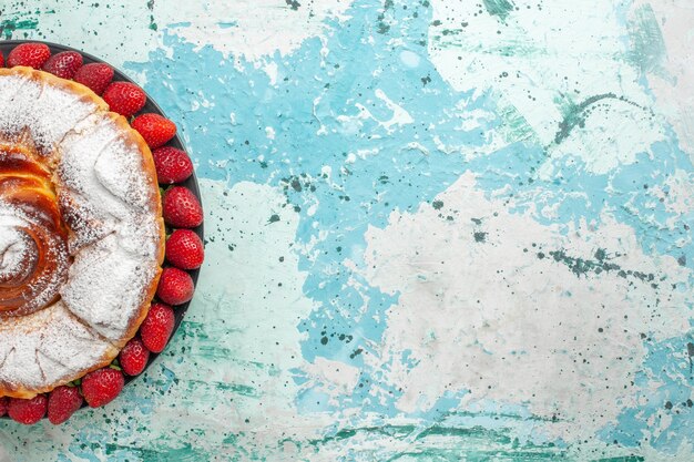 Top view sugar powdered cake with fresh red strawberries on light-blue desk