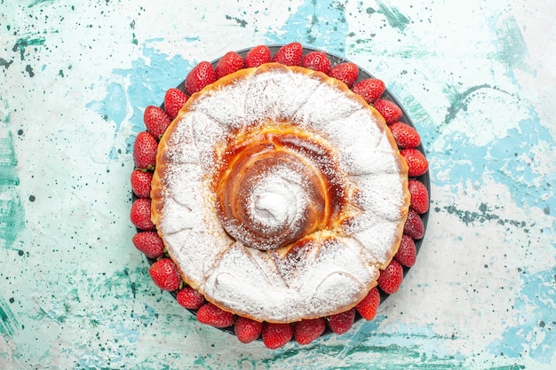 Top view sugar powdered cake with fresh red strawberries on light-blue surface