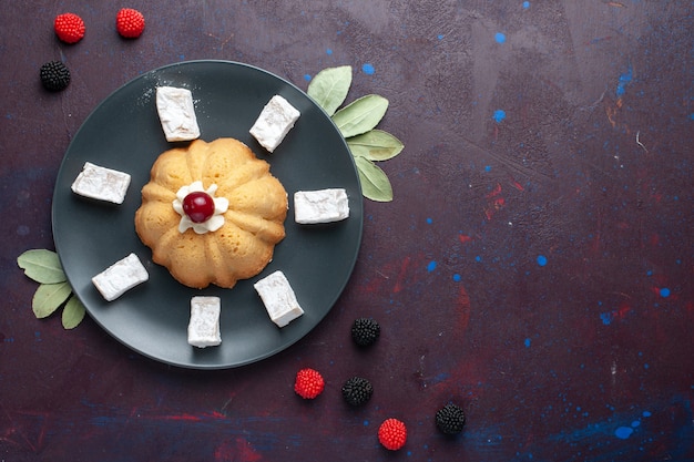 Top view of sugar powdered candies delicious nougat with cake and confiture berries on dark surface