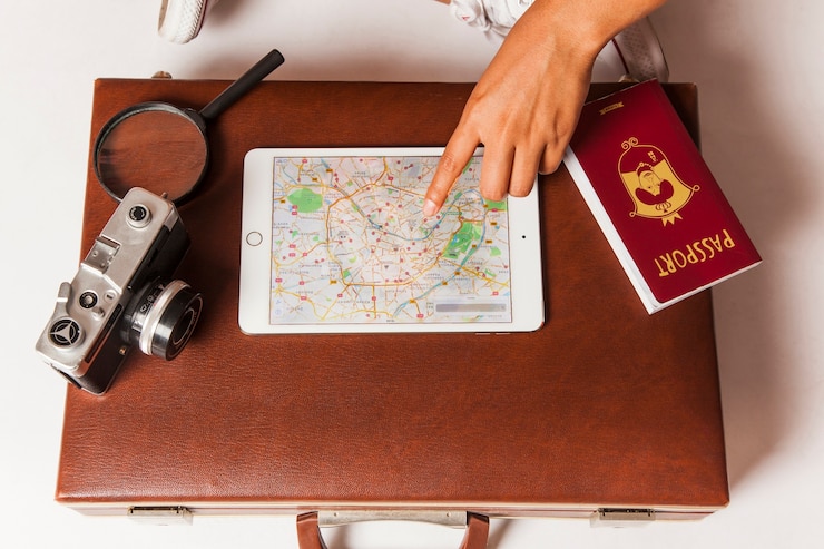 Free Photo top view of suitcase with camera and passport