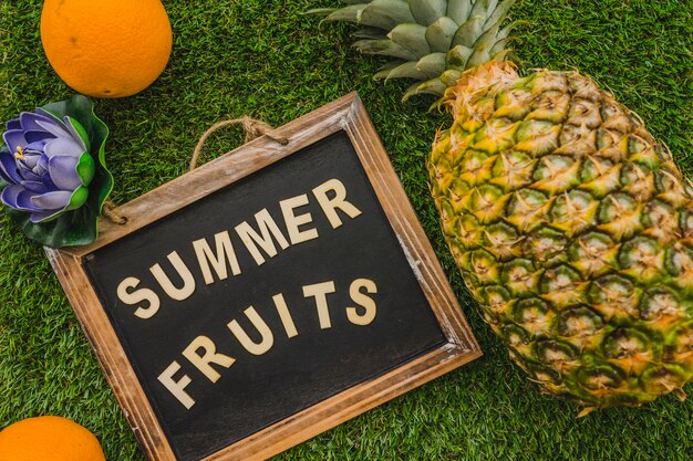 Top view of summer composition with decorative slate and fruits