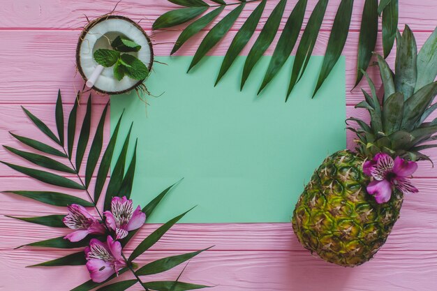 Top view of summer composition with paper and fruits