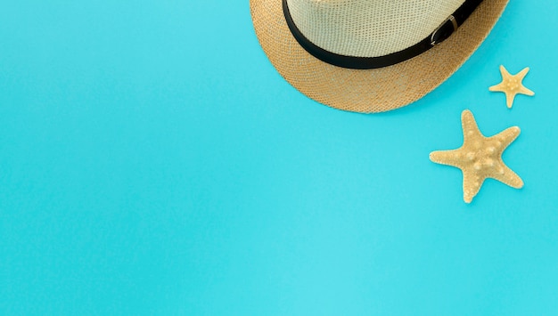 Top view summer hat and starfish with copy space