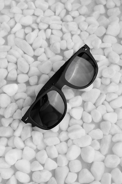Top view over sunglasses floating on water
